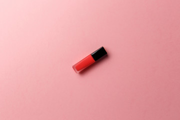 Red lipstick on a pastel pink background. Promotion of luxury fashion cosmetic brand. The concept of fashion and beauty. Top view. Flat lay. Copy space. Fashion blog design