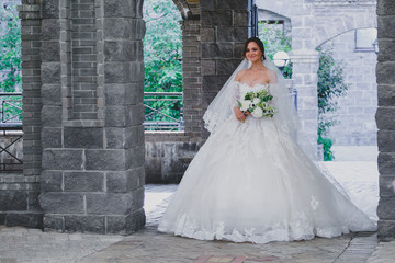 Seductive young bride posing on the territory of country hotel