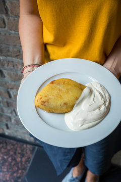 Midsection of woman holding food on plate