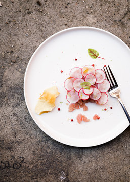 Overhead view of radish slices with meat served on plate