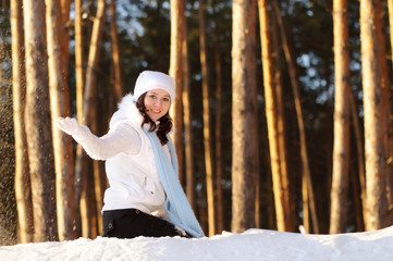 Cute girl peeks out from behind tree