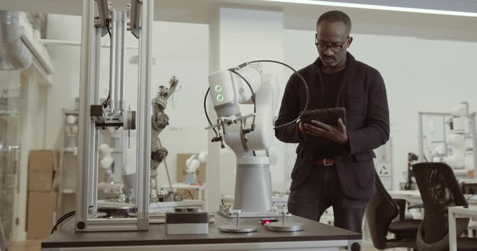 Engineer programming robotic arm