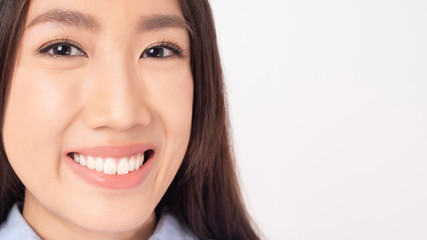 Close up of Asian woman with beautiful teeth on white background