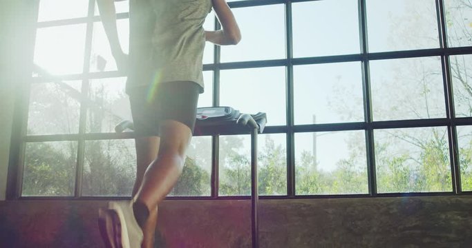 Man running on treadmill in home fitness gym.