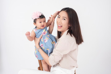 Asian mother and adorable baby girl are  happy on white background