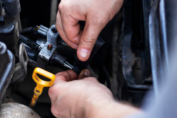 A man repairs a car himself