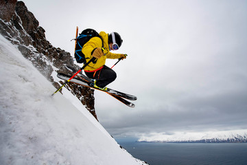 A man backcountry skiing to the ocean at in Iceland.