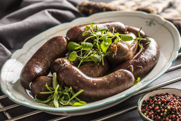 Roasted sausages in pan with rosemary. Traditional european food bratwurst jaternice or jitrnice