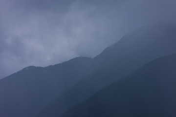 Franz Jozef Glacier New Zealand. Mountains and clouds. Fog - obrazy, fototapety, plakaty
