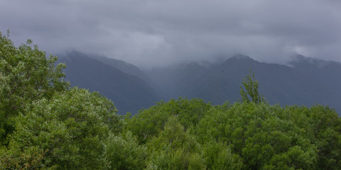 Fototapeta na wymiar Franz Jozef Glacier New Zealand. Mountains and clouds. Fog
