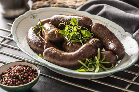 Roasted sausages in pan with rosemary. Traditional european food bratwurst jaternice or jitrnice