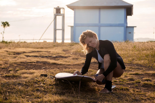 Woman preparing for surfing