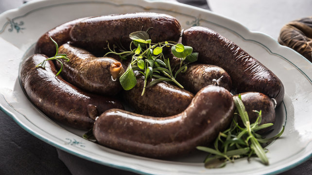 Roasted sausages in pan with rosemary. Traditional european food bratwurst jaternice or jitrnice