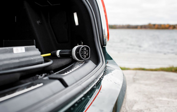 Electric car lead in the trunk of a car at the beach