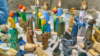 Wooden toys of angels, dogs, elks. Folk art and craft concept.