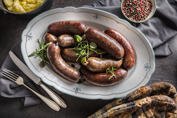 Roasted sausages in pan with rosemary. Traditional european food bratwurst jaternice or jitrnice