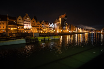 Fototapeta na wymiar Gdansk, Poland - Juny, 2019. Evening view over the river Motlawa the Old Town in Gdansk, Poland.