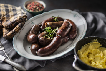 Roasted sausages in pan with rosemary. Traditional european food bratwurst jaternice or jitrnice