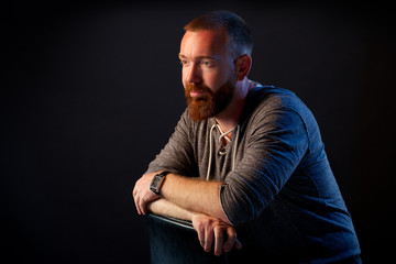 brutal man with a beard in the studio