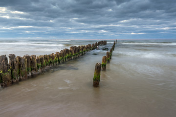 Debki beach with breakwater at cloudy day. Baltic Sea, Poland.