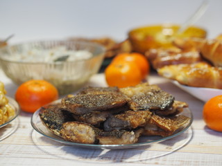 Fish diet. Fish table, XE salad of freshly salted river fish with olive oil, fish cakes, fried river fish on a wooden white rustic background or table.