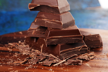 Dark chocolate stack, chips and powder with chocolate bars and block