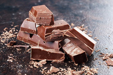 Dark chocolate stack, chips and powder with chocolate bars and block