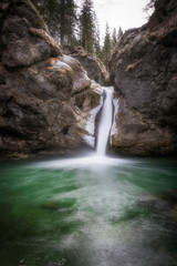 Fototapeta na wymiar green water in the pool below the buchenegg waterfall, Allgaeu Alps, Steibis, Germany