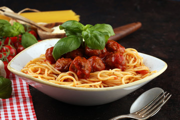 Spaghetti pasta with meatballs and tomato sauce with basil and parmesan