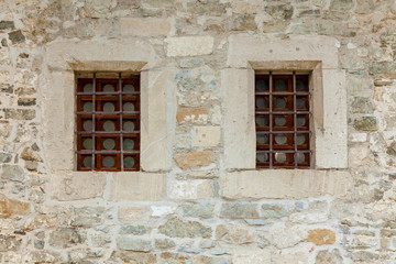 Fototapeta na wymiar An old stone wall with windows