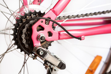 Rear mountain bike cassette on the wheel with chain, pink frame of bicycle, isolated on white background