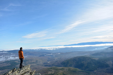 Fototapeta premium man observes the landscape from the top of the mountain . Peña de Francia, Salamanca, Spain. Space for text. Concept: freedom