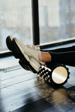 Woman Using Foam Roller for Muscle and Fascia Stretching