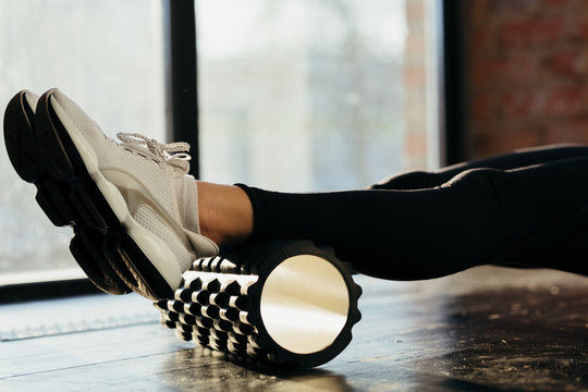Woman Using Foam Roller for Muscle and Fascia Stretching