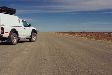 Fototapeta na wymiar white car in desert on road