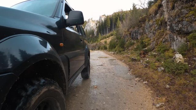Point of view off-road car driving on a mountain road