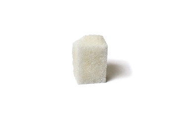 Single sugar lump with sugar crumbs isolated of white