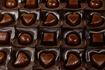 Assorted chocolate candies in a box. Close-up