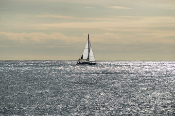 Sailboat at calm sea on midday, sailing boat in mediterranean sea