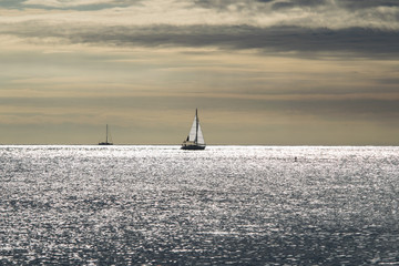 Sailboat at calm sea on midday, sailing boat in mediterranean sea