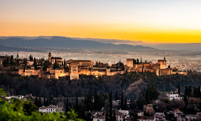 Fototapeta na wymiar Sunset with the illuminated Alhambra in Granada and a beautiful sky