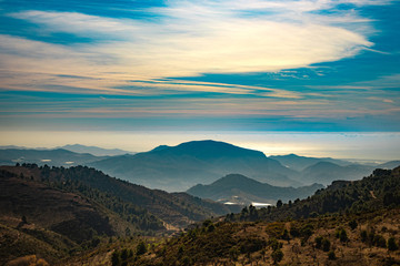 Nice landscape with a cloudy blue sky and mountains