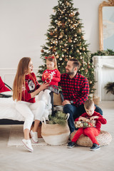 Portrait of smiling young family on Christmas day. Togetherness concept