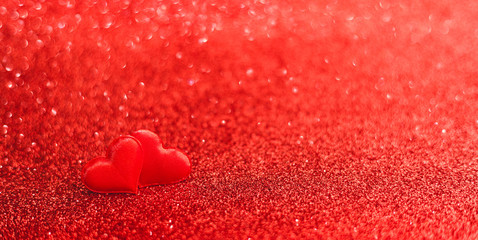 Two red hearts on a red background of sparkles. Valentines day, love, romance, dating concept, long banner with Copy space. Stock photo Valentine day card.