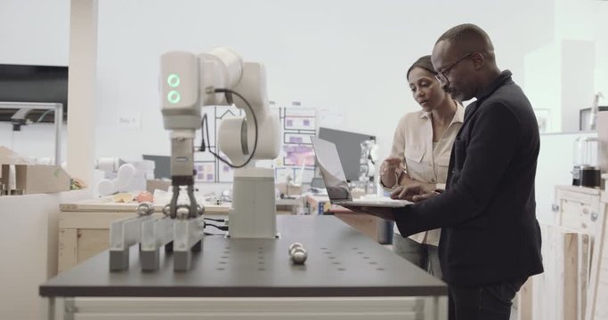 Engineers working on a robotic arm