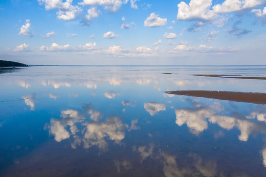 Reflection of clouds in the water surface of the Gulf of Finland © alexkazachok