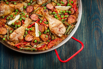 Traditional paella with chicken legs, sausage chorizo and vegeta