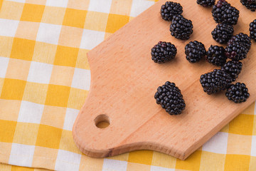 Blackberries on wooden kitchen board. Cooking berries.