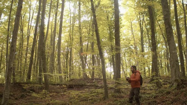 Man photographer taking photographs in La Fageda in La Garrotxa (Girona, Catalonia) with awesome landscape Concept: Amateur of photography and Catalonia spectacular landscapes