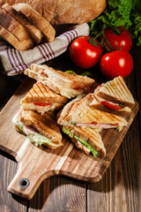 Stack of panini with ham, cheese and lettuce sandwich